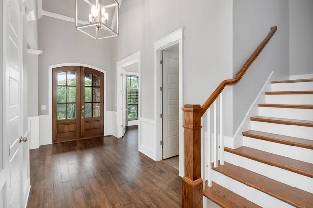 a view of a livingroom with wooden floor and windows