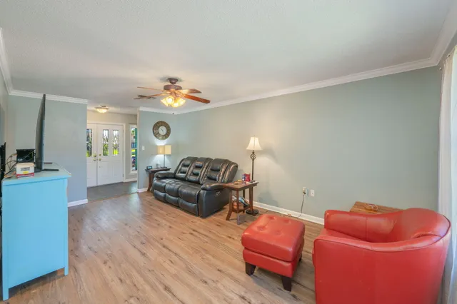 a kitchen with stainless steel appliances a refrigerator stove and white cabinets