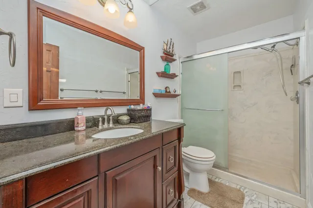 a bathroom with a sink a toilet and shower curtain