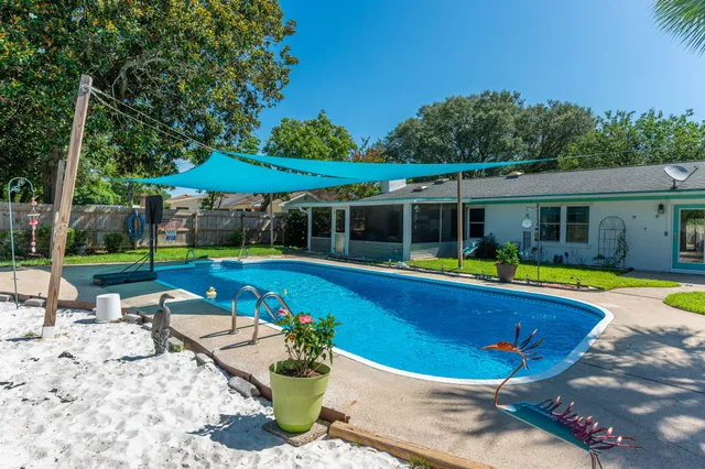 a swimming pool with outdoor seating and yard