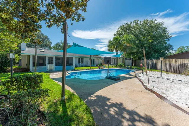 a view of a house with backyard and porch
