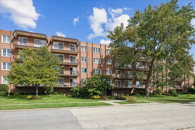 a front view of a building and a garden