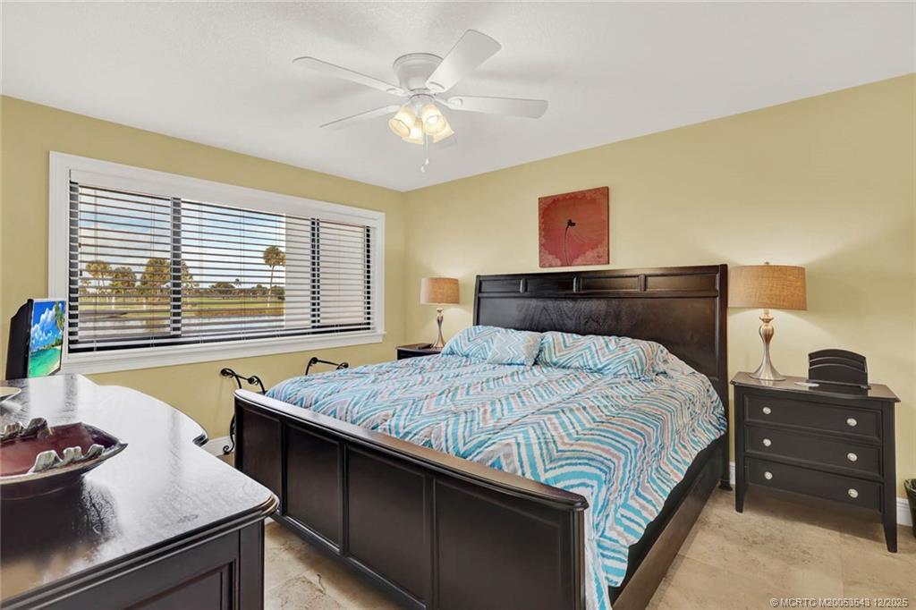 40 Northeast Plantation Road, Unit 101 Stuart, FL 34996 - Photo 14 of 37 a bedroom with a bed and dresser with mirror
