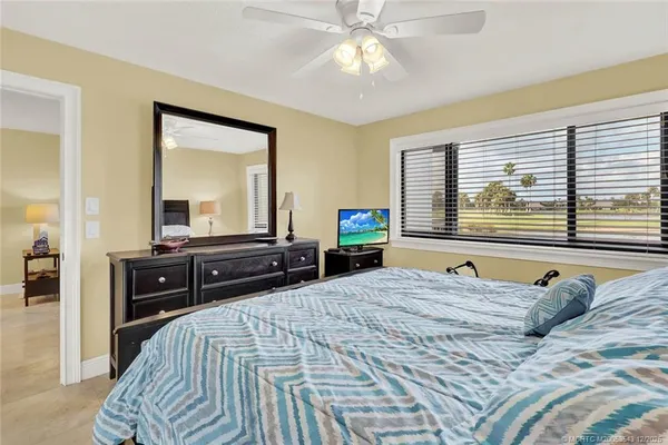 a bedroom with a bed and a large mirror with a flat tv screen