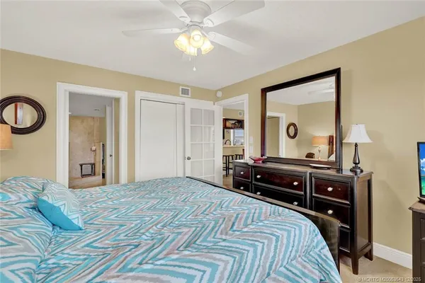 a bedroom with a bed and a chandelier