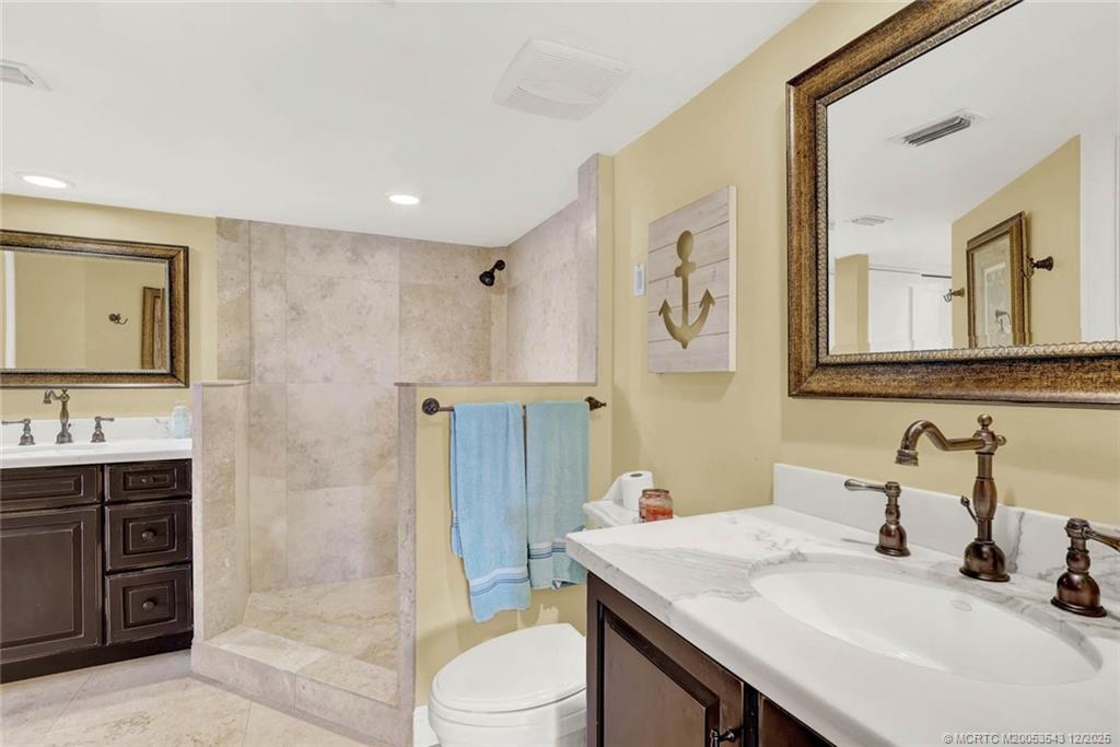 40 Northeast Plantation Road, Unit 101 Stuart, FL 34996 - Photo 19 of 37 a bathroom with a sink a toilet and shower