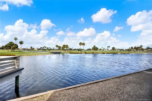 a view of a lake with houses in the back