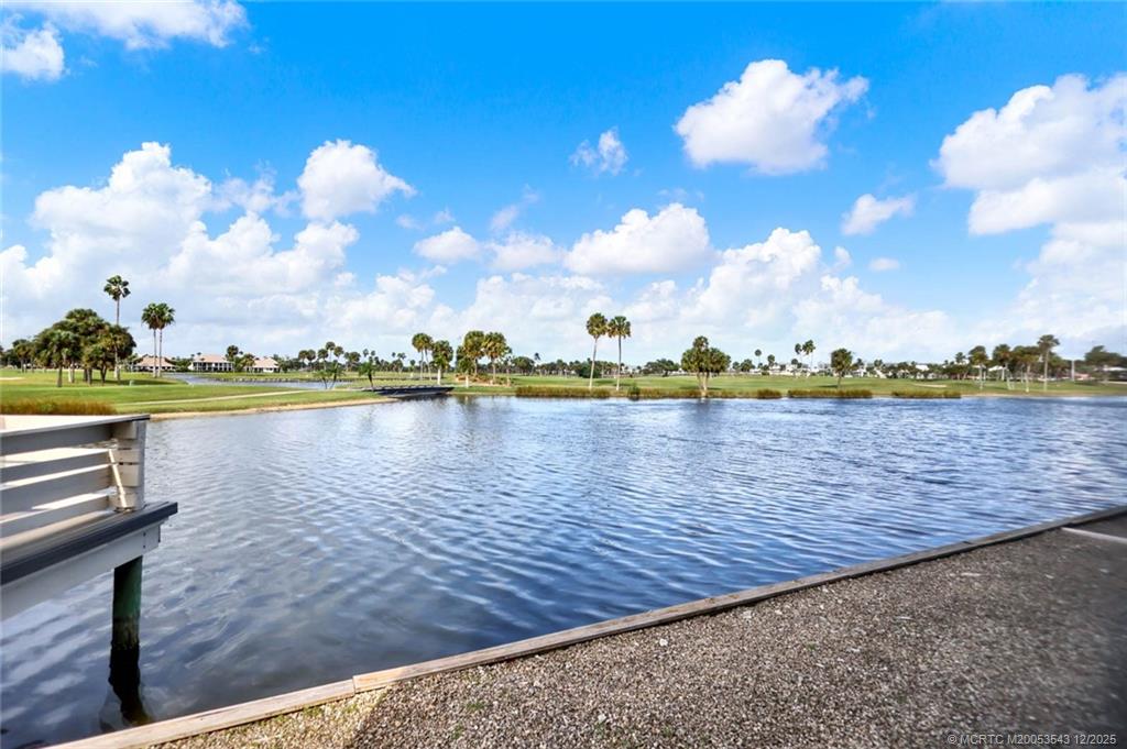 40 Northeast Plantation Road, Unit 101 Stuart, FL 34996 - Photo 27 of 37 a view of a lake with houses in the back