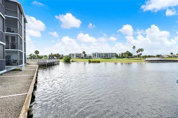 a view of a lake with houses in the background