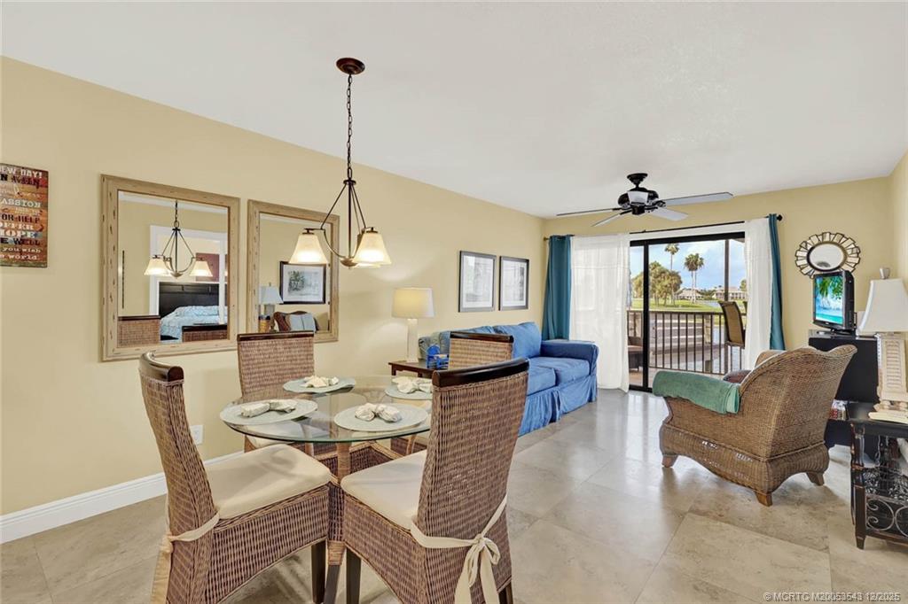 40 Northeast Plantation Road, Unit 101 Stuart, FL 34996 - Photo 3 of 37 a living room with furniture and wooden floor