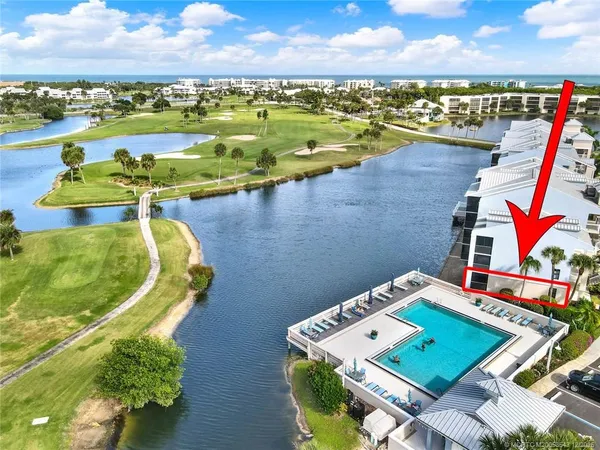 an aerial view of a house with a ocean view