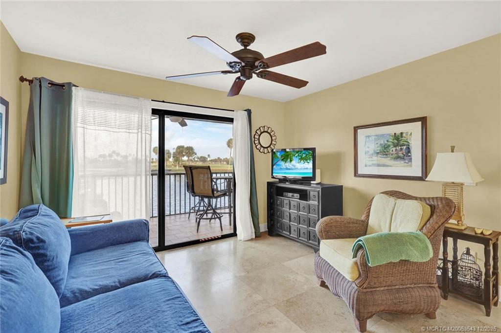 40 Northeast Plantation Road, Unit 101 Stuart, FL 34996 - Photo 5 of 37 a living room with furniture and a large window