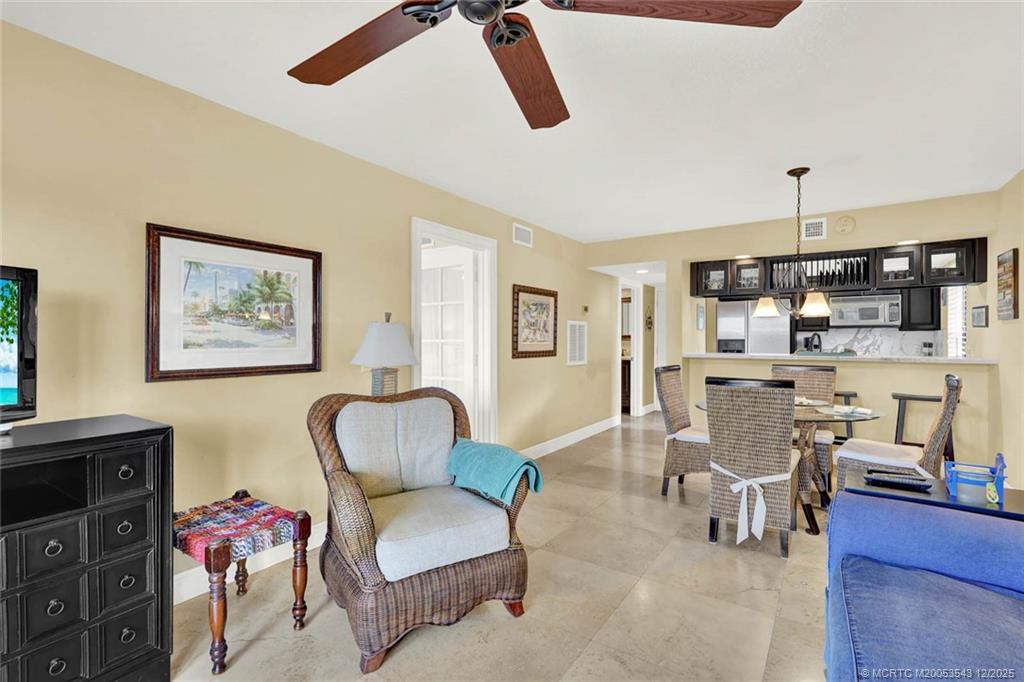 40 Northeast Plantation Road, Unit 101 Stuart, FL 34996 - Photo 6 of 37 a living room with furniture and kitchen view