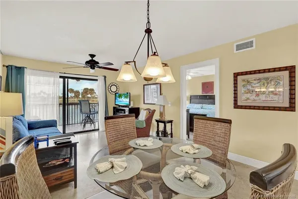 a dining room with furniture a rug and a chandelier