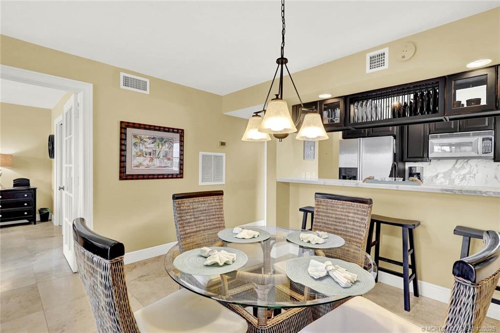 40 Northeast Plantation Road, Unit 101 Stuart, FL 34996 - Photo 8 of 37 a view of a dining room with furniture