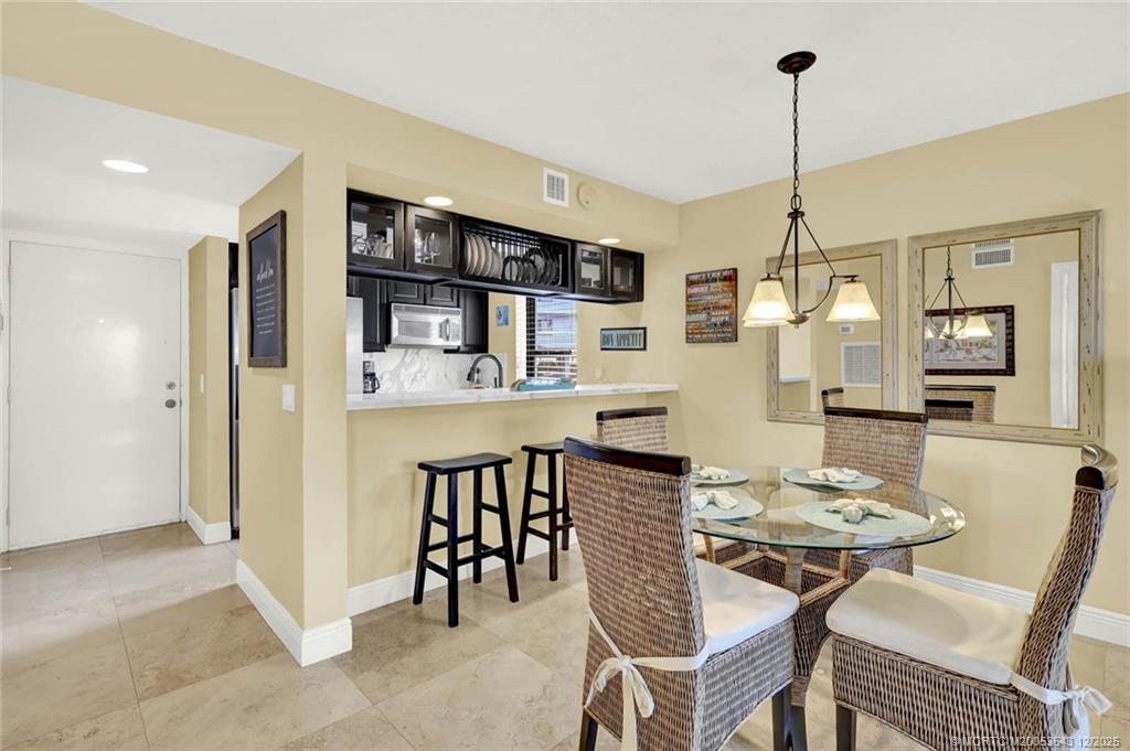 40 Northeast Plantation Road, Unit 101 Stuart, FL 34996 - Photo 9 of 37 a view of a dining room with furniture