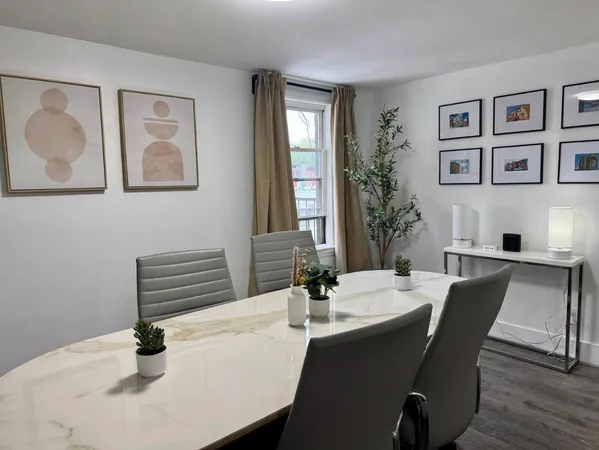 a dining room with furniture and window