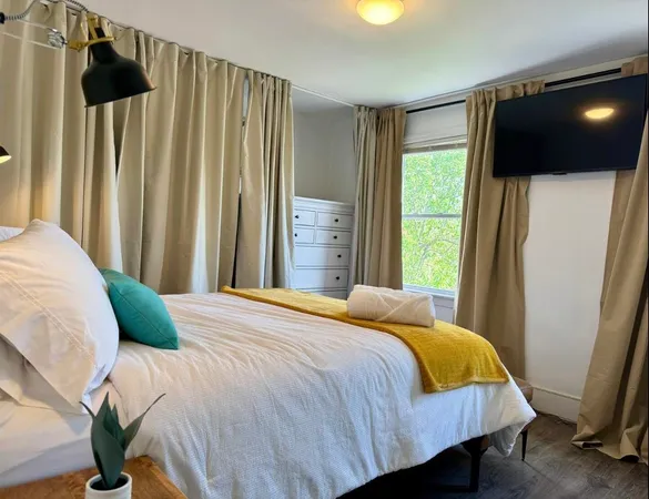 a bedroom with a bed and a television