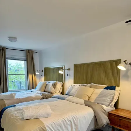 a bed sitting in a bedroom next to a window