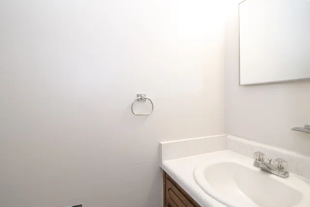 a bathroom with a sink and mirror