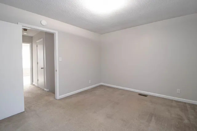a bathroom with a granite countertop sink and a toilet
