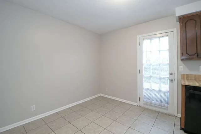 a view of empty room with window and fireplace