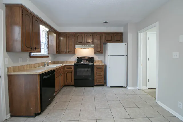 a kitchen with a stove top oven and sink