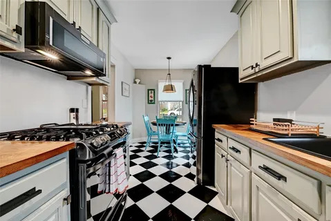 a kitchen with stainless steel appliances granite countertop a stove and a refrigerator