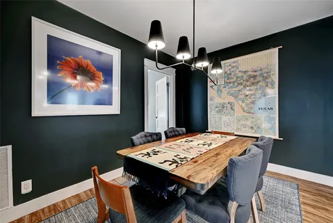 a dining room with a wooden table and chairs