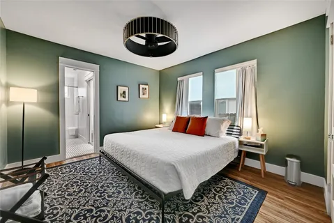 a bedroom with a large bed and a chandelier