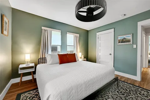 a bedroom with a large bed and a chandelier