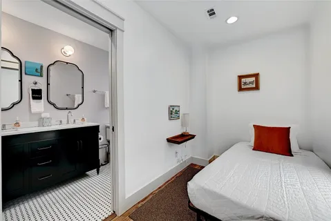 a bedroom with a bed and a dresser