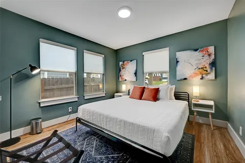 a bedroom with a bed and wooden floor