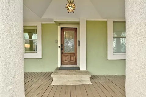 a view of a room with wooden floor and staircase
