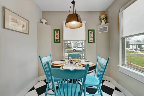 a dining room with furniture and window