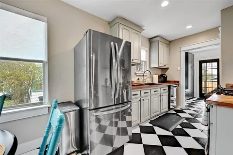 a kitchen with a refrigerator a sink and a window