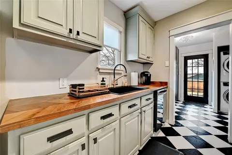a kitchen with stainless steel appliances a sink stove and cabinets