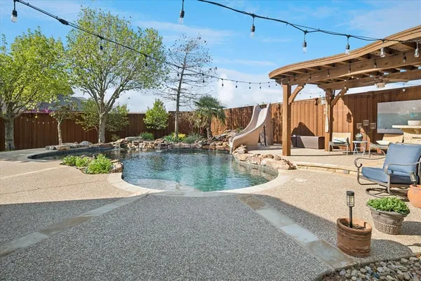 a view of a swimming pool with a patio