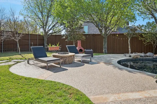 a view of a backyard with a sitting area