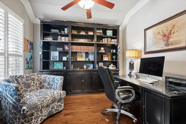 a view of a workspace with furniture and a bookshelf