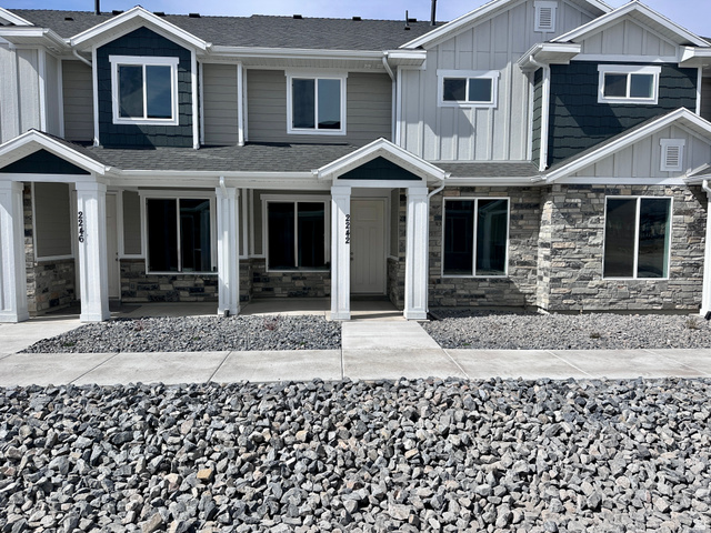 2242 South 1120 West, Unit 69 Logan, UT 84321 - Photo 1 of 26 Craftsman-style home featuring stone siding, roof with shingles, board and batten siding, and a porch