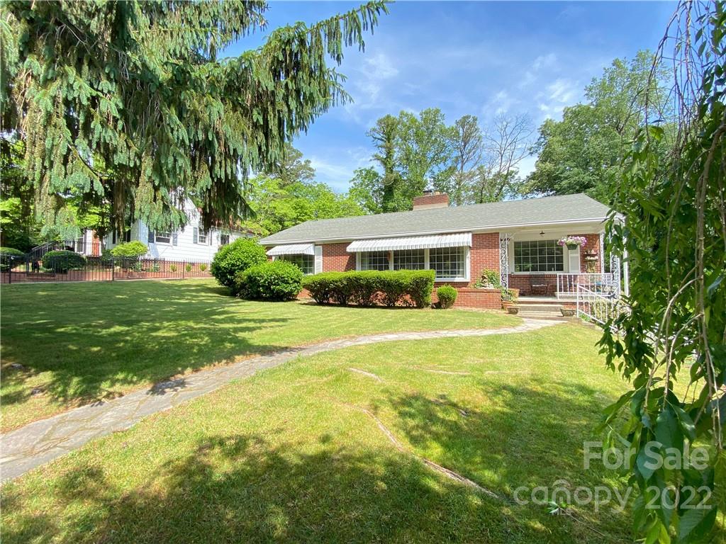 19 Osborne Road Asheville, NC 28804 - Photo 1 of 35 a front view of a house with a yard table and chairs