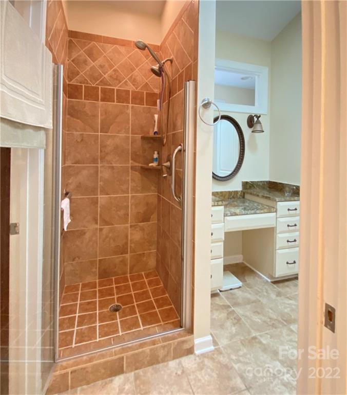 19 Osborne Road Asheville, NC 28804 - Photo 12 of 35 a bathroom with a shower a mirror and a sink