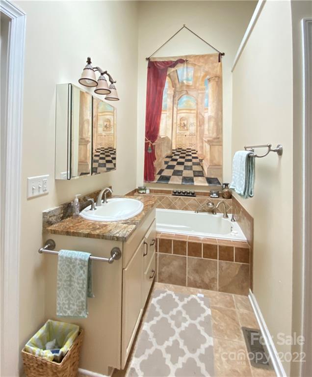 19 Osborne Road Asheville, NC 28804 - Photo 13 of 35 a bathroom with a granite countertop sink a toilet a mirror and shower