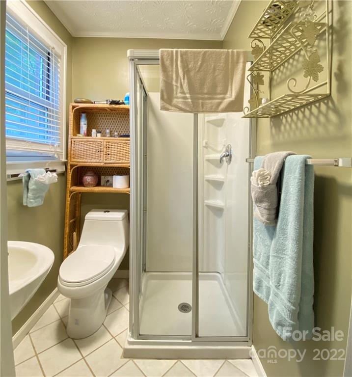 19 Osborne Road Asheville, NC 28804 - Photo 16 of 35 a bathroom with a toilet and a shower