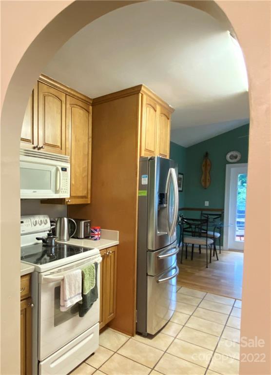 19 Osborne Road Asheville, NC 28804 - Photo 9 of 35 a kitchen that has a refrigerator and a stove