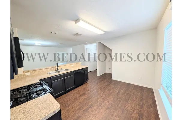 a view of a kitchen with kitchen island wooden floor and window