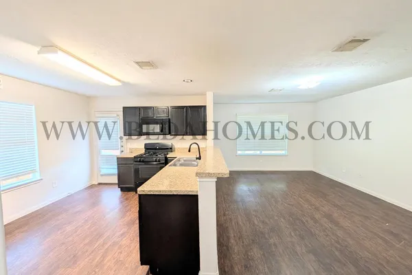a view of kitchen with furniture and wooden floor