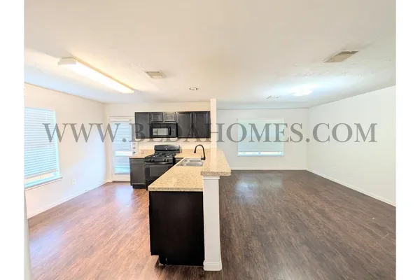 a view of kitchen with furniture and wooden floor