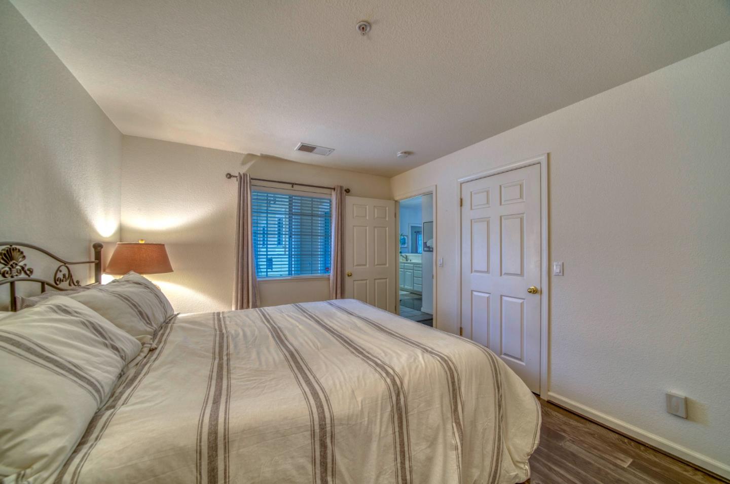 121 Skyline Drive San Ramon, CA 94583 - Photo 20 of 38 a spacious bedroom with a bed and a lamp